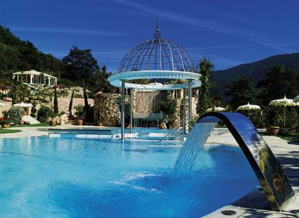 Ein Außenpool mit Wasserbogen, Pavillon und Bergkulisse im Preidlhof.