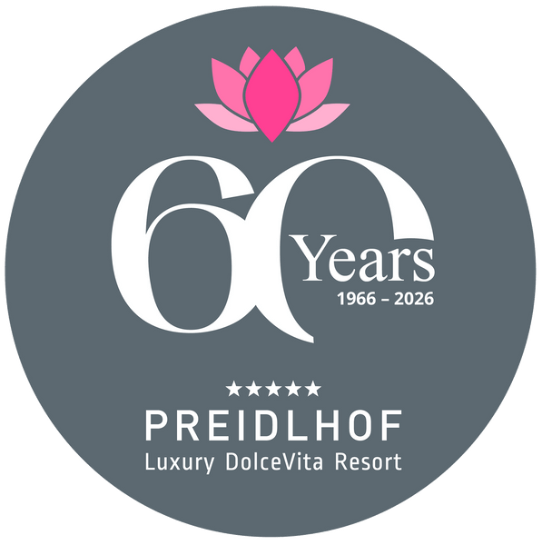 Un logo circolare di Preidlhof mostra un fiore di loto rosa, la scritta 60 Years 1966–2026 e Luxury DolceVita Resort.